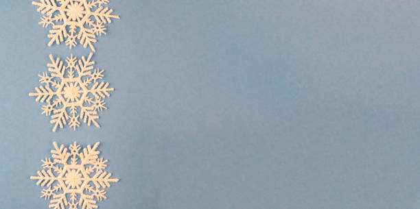 istock Snowflakes for New Year's decor on a blue background with space for text. Christmas layout. 1286746007