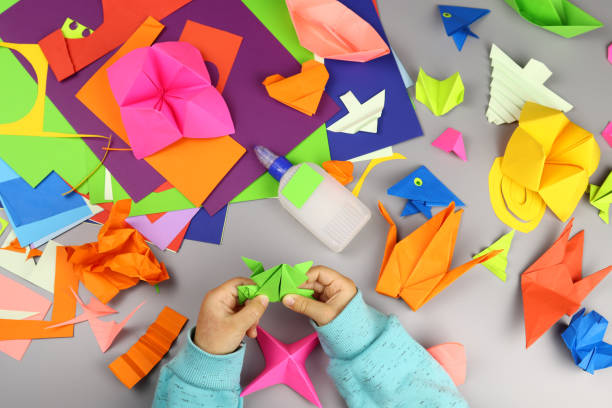 istock child makes origami crafts from colored paper 1286746325