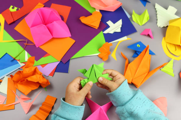 istock child makes origami crafts from colored paper 1286746531