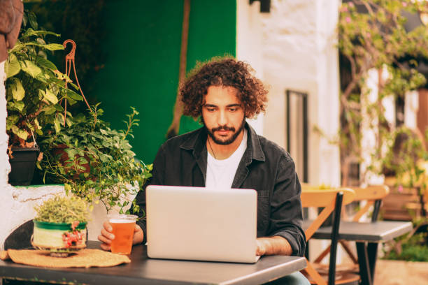 istock Handsome Young Man Working Freelance in Cafe 1286747573