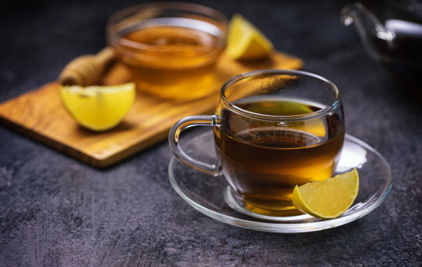 istock Cup of hot tea served with honey and lemon 1286747601