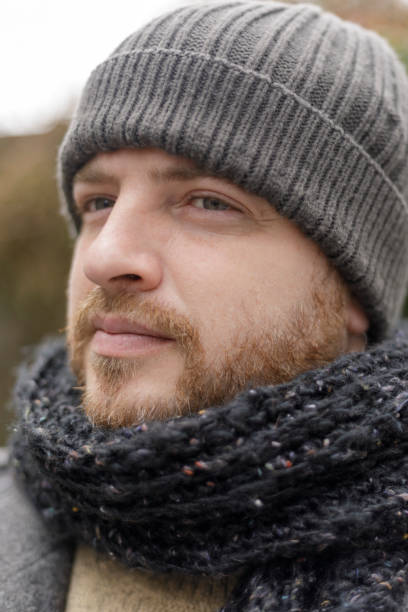 istock Selective focus shot of a man wearing a knitted scarf and hat 1286747672