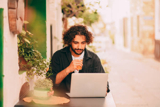 istock Handsome Young Man Working Freelance in Cafe 1286747687