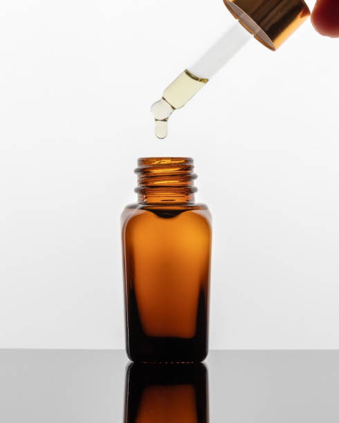 istock A drop of essential oil falling into a bottle 1286750027