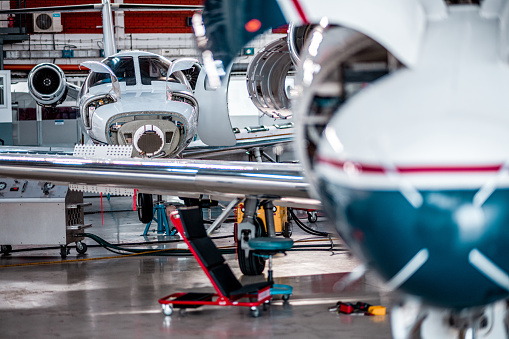 Aircraft jet engines maintenance and inspection in the airplane hangar before the flights.