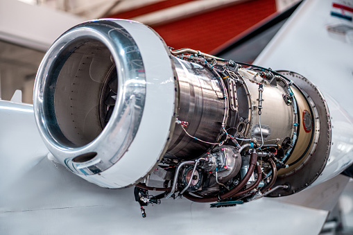 Aircraft jet engine maintenance and inspection in the airplane hangar.