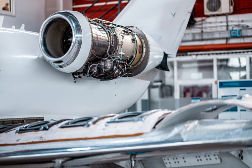 Aircraft jet engine maintenance in the airplane hangar.