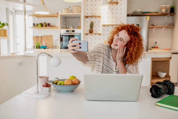 istock Young woman is taking a break from working on a laptop and taking selfie 1286754175