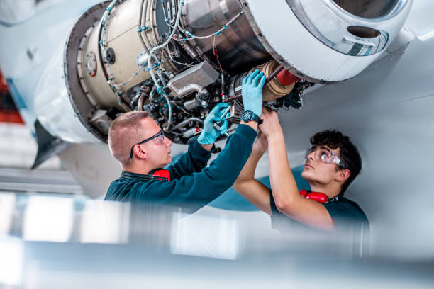 istock Aircraft mechanics working on a jet engine in the airplane hangar 1286754279