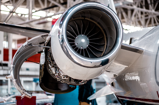 Aircraft jet engine inspection in the airplane hangar before the flight.