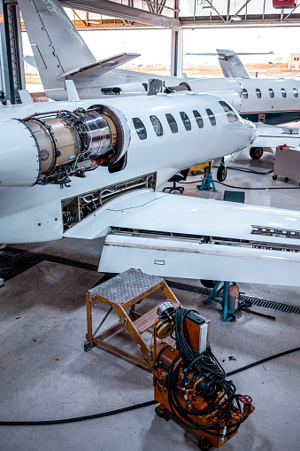 The usual maintenance of the private airplanes in the airplane hangar before the departure.