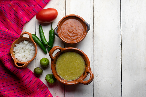 Traditional mexican red and green sauce on white background