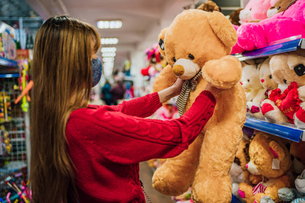 istock Woman choosing teddy bear in a toy store 1286755192