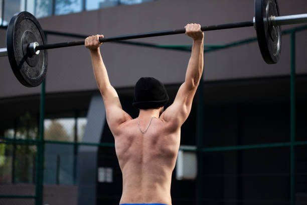 istock man working bodybuilding by lifting weights barbell 1286757176