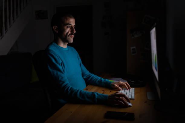 istock Man working at home office desk at night 1286758796