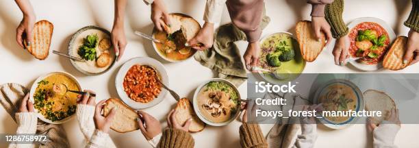 People Eating Various Autumn And Winter Creamy Vegan Soups Together Stock Photo - Download Image Now