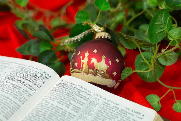 istock Nativity Red Christmas Ornament with Open Bible. 1286760913