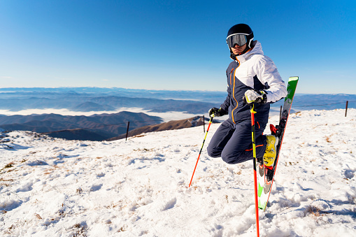 close up view of various persons wearing skis while moving on the snow in the morning, in winter