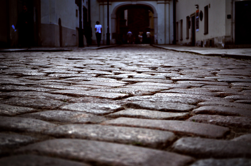 cobblestones in the old town in Warsaw alley gate on the market square path between tenement houses gate