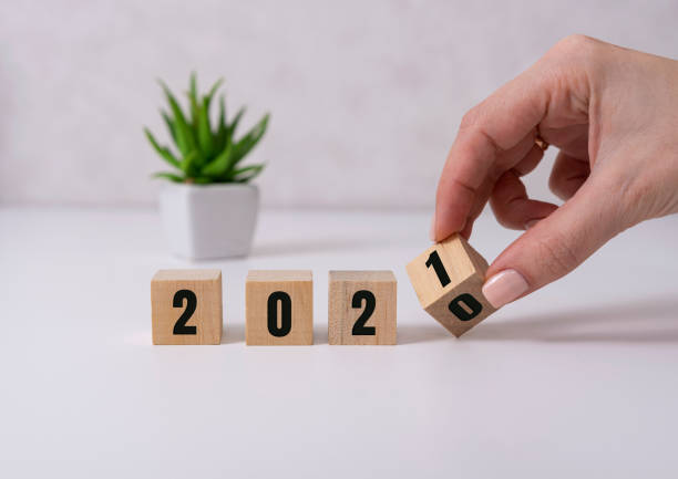 istock Hand turns a dice and changes the year 2020 to 2021 . 1286766577