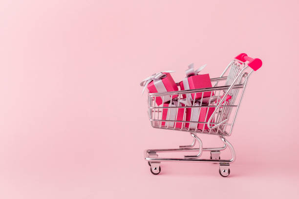 istock Mini cart filled with pink gift paper boxes 1286766600
