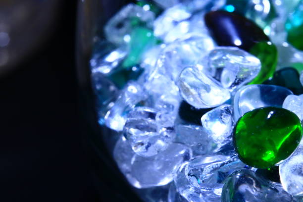 istock Fantastic green and white precious gemstones shining suspiciously against a dim dark background 1286767348
