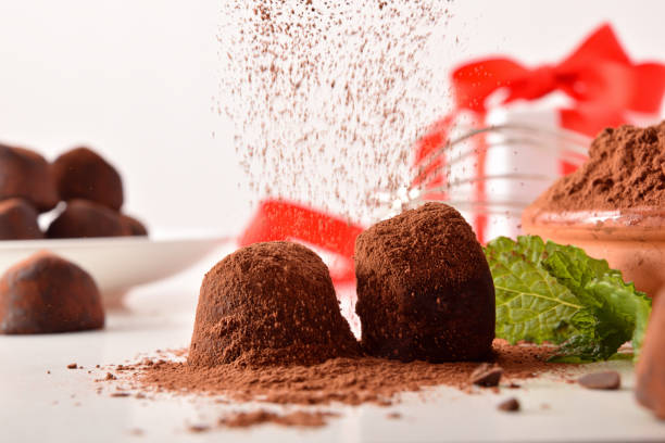 istock Cocoa powder falling on chocolate truffles prepared for an event 1286767503