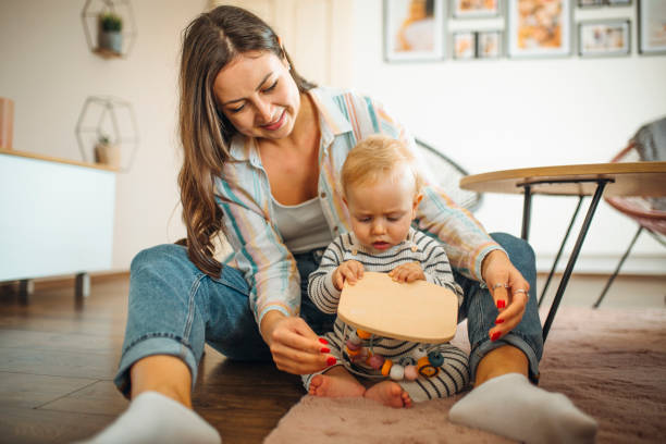 istock Young mom plays with her baby 1286768150