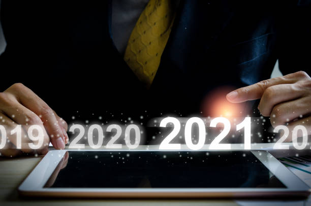 istock businessman hand touching on 2021 virtual screen. 1286768290