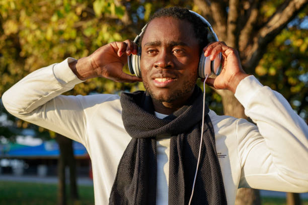 istock African man with headphones in the park 1286769121