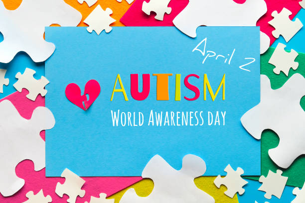 istock Creative design for Autism World day, April 2. Panoramic awareness banner, hands hold red heart 1286770346