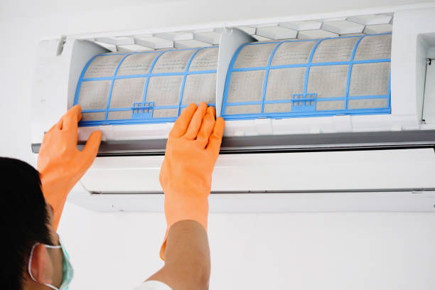 istock Asian man cleaning air conditioner dirty filter 1286771875