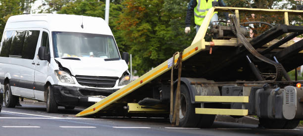 istock Wrecked minibus stands next to tow truck closeup 1286772105