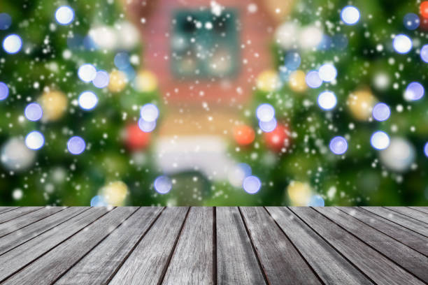 istock Empty wooden table top with blurred Christmas tree background 1286772272