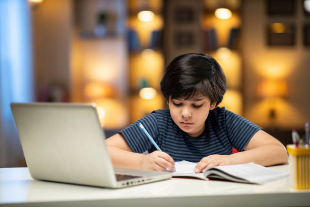 istock Boy doing his homework stock photo 1286774055
