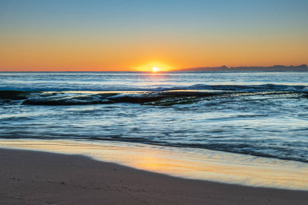 istock Clear skies and small waves, dawn at the beach 1286781488