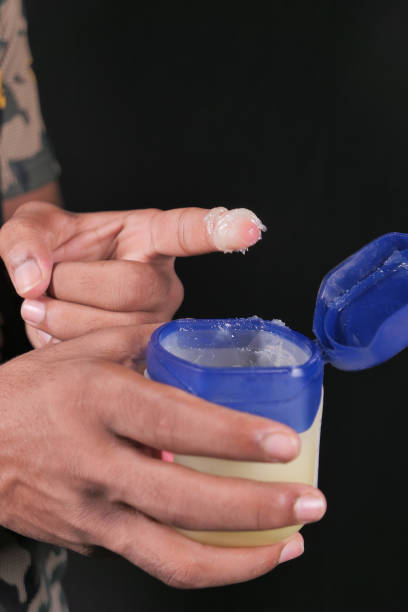 istock Close up of man hand using petroleum jelly 1286785261