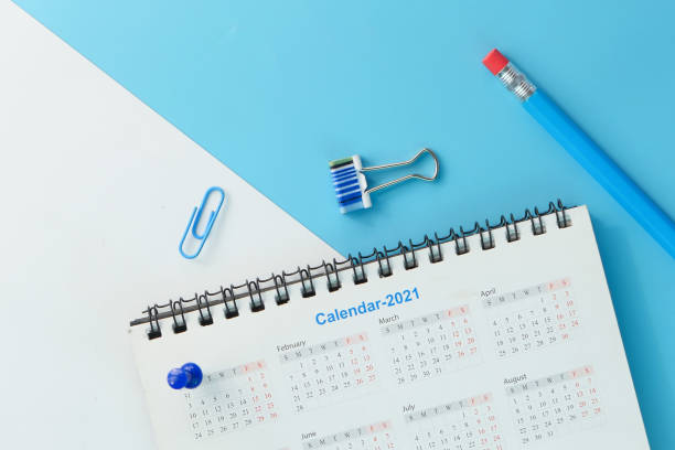 2021 calendar with pen and push pin on color background