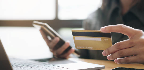 istock Hands holding credit card and using laptop. Online shopping 1286785921