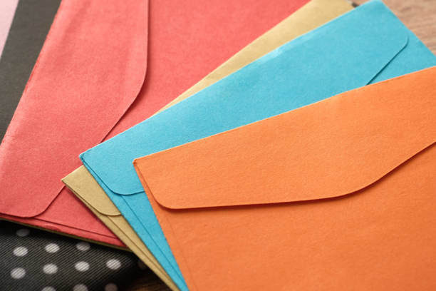 istock colorful envelope on wooden background with copy space. 1286786641