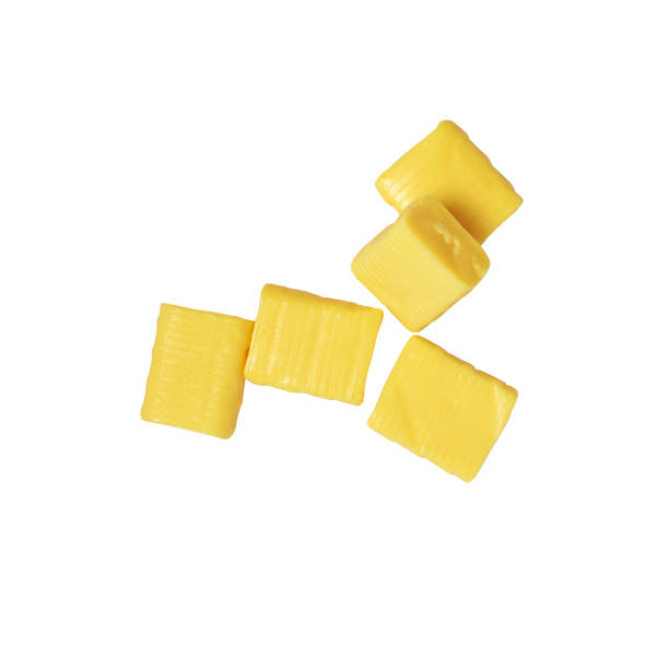 five yellow rectangular chewy candy on a white, mamba stock photo