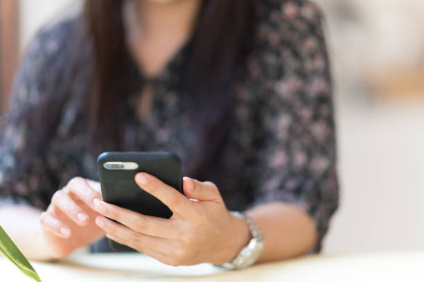 istock Close up A working woman with a mobile phone to check e-mail 1286793853