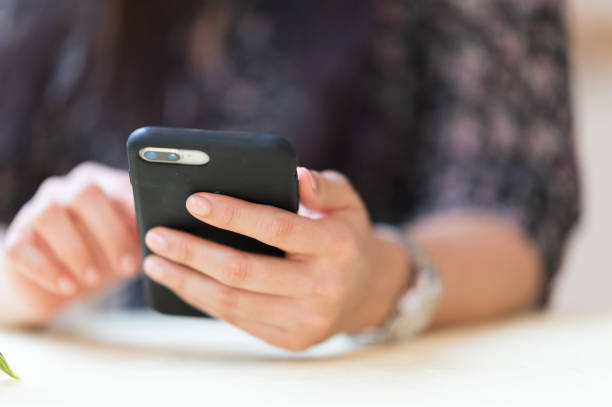 istock Close up A working woman with a mobile phone to check e-mail 1286794416