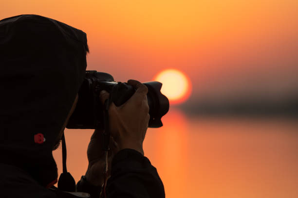 istock Photographer tourists taking pictures during sunset Silhouette  time. 1286794432