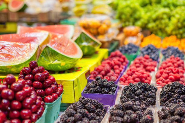 Fruits at market Granville Island Market Vancouver Canada Fruit stand at the Granville Island Public Market in downtown Vancouver, BC, Canada granville island stock pictures, royalty-free photos & images