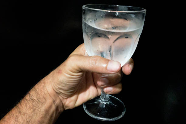 istock Hand holding glass cup with cold water 1286798390