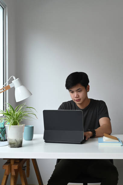 istock Portrait of a freelance graphic designer man is working on computer tablet at his modern workspace. 1286801921