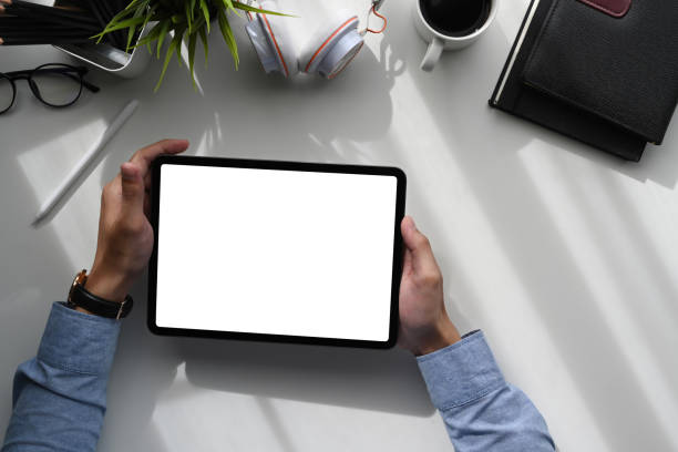 istock Top view of a young creative graphic designer hands holding digital tablet on white table. 1286801924