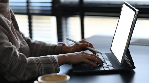 istock Cropped shot of a young female worker is typing on computer tablet at her workspace. 1286801936