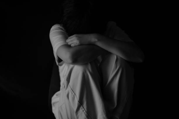 A woman in sadness A woman in sadness hugging knees stock pictures, royalty-free photos & images